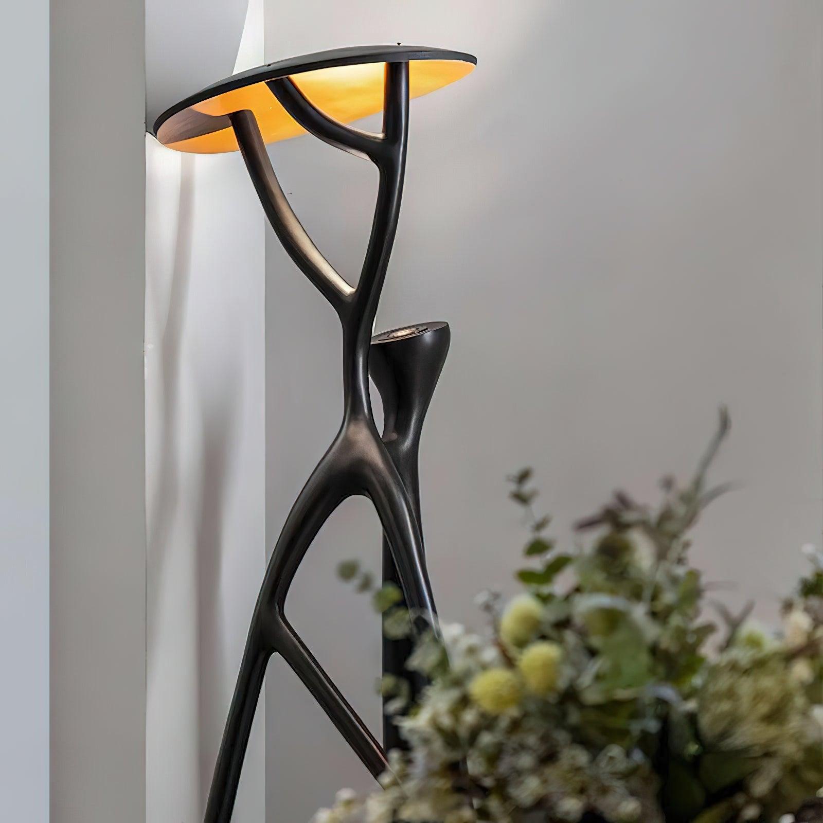 Blonski sculptural floor lamp close-up low-angle view in residential corner, warm glowing interior lighting
