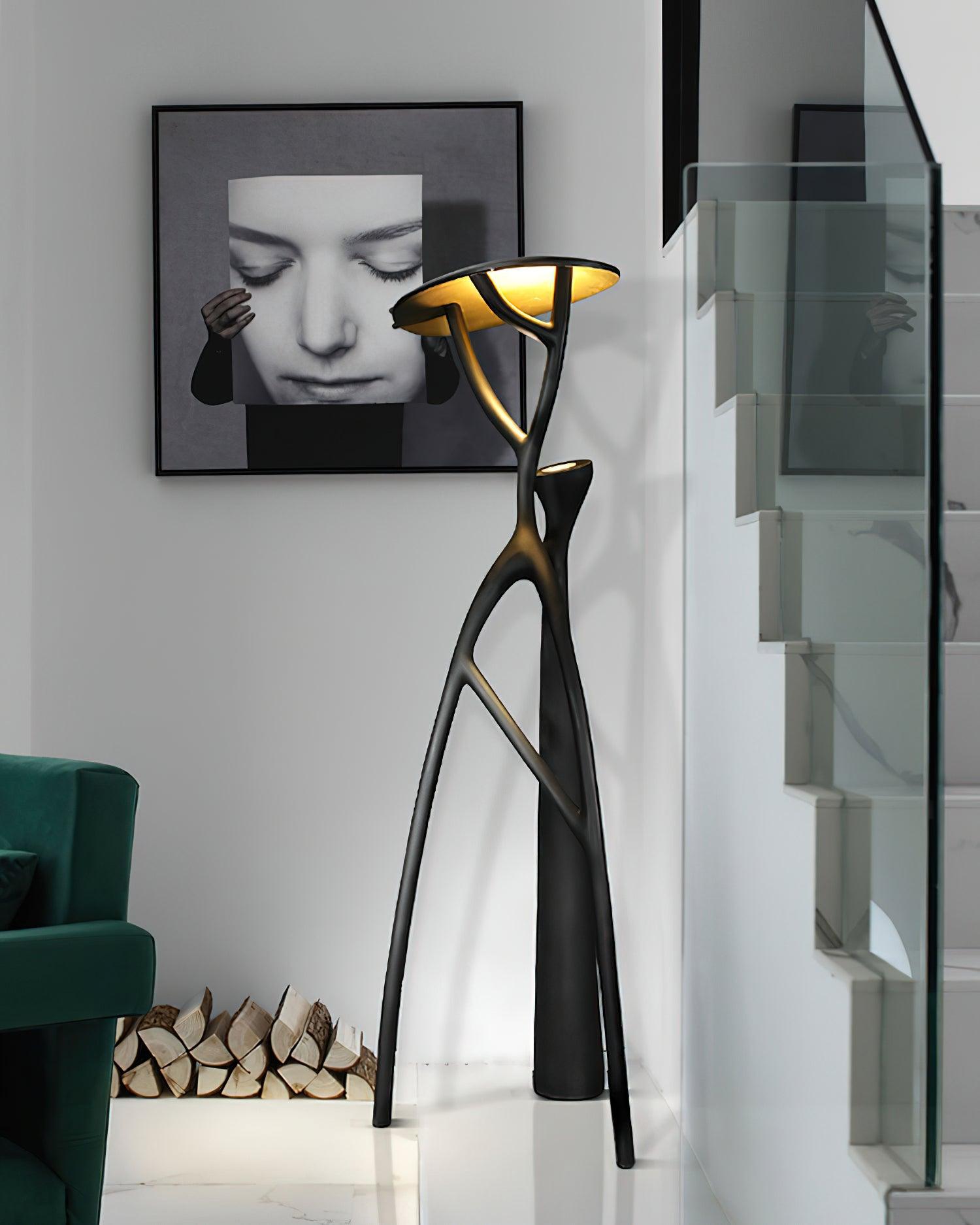 Blonski sculptural floor lamp side view near modern glass staircase, matte black finish contemporary decor
