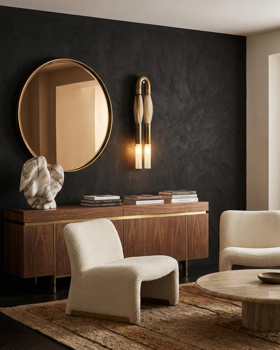 Branwick wall sconce installed in luxury vanity entryway above round mirror with warm neutral interior design aesthetic