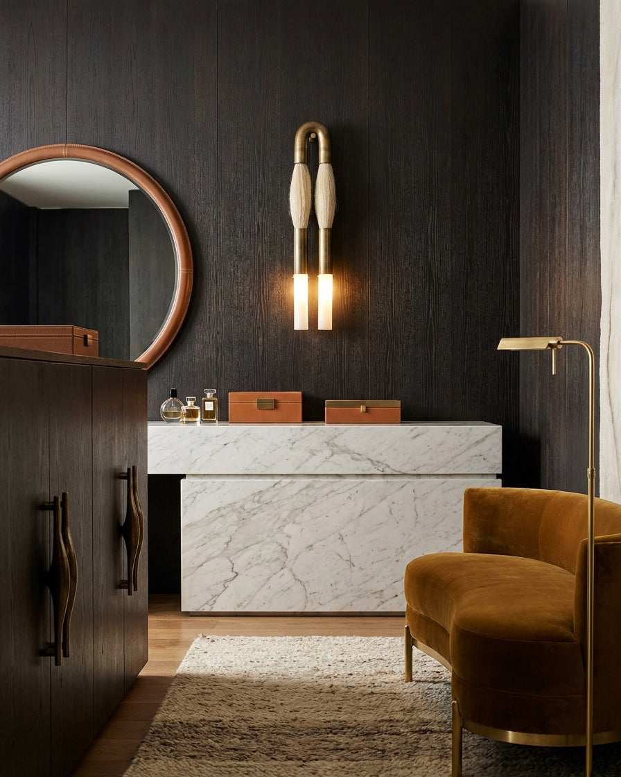 Branwick sculptural wall sconce above luxury velvet seating lounge with dark wood panel wall and marble countertop