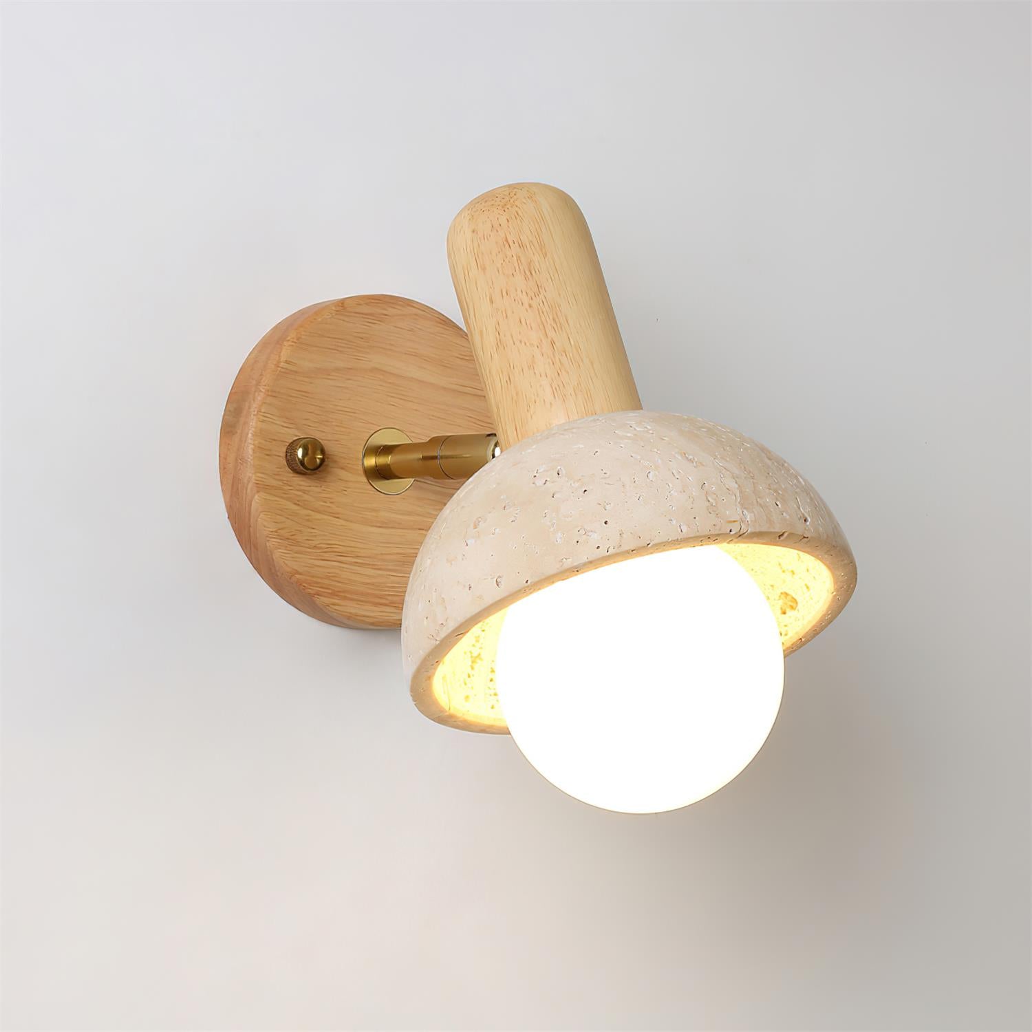 Modern travertine wall sconce light with blonde oak wood fixture and brass mounting hardware
