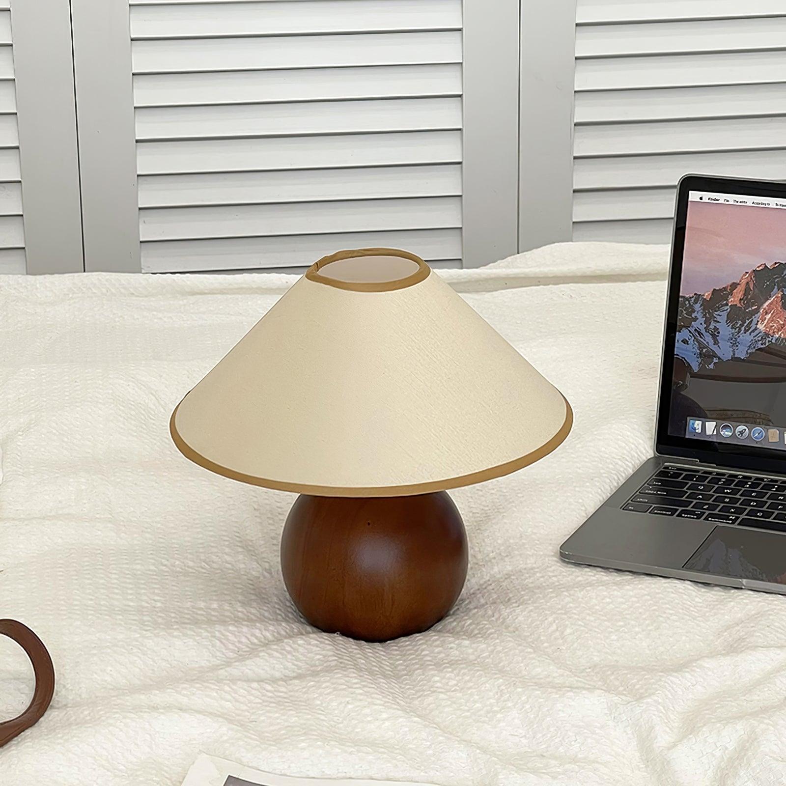 Contemporary wooden table lamp with natural grain details and fabric shade, product styling