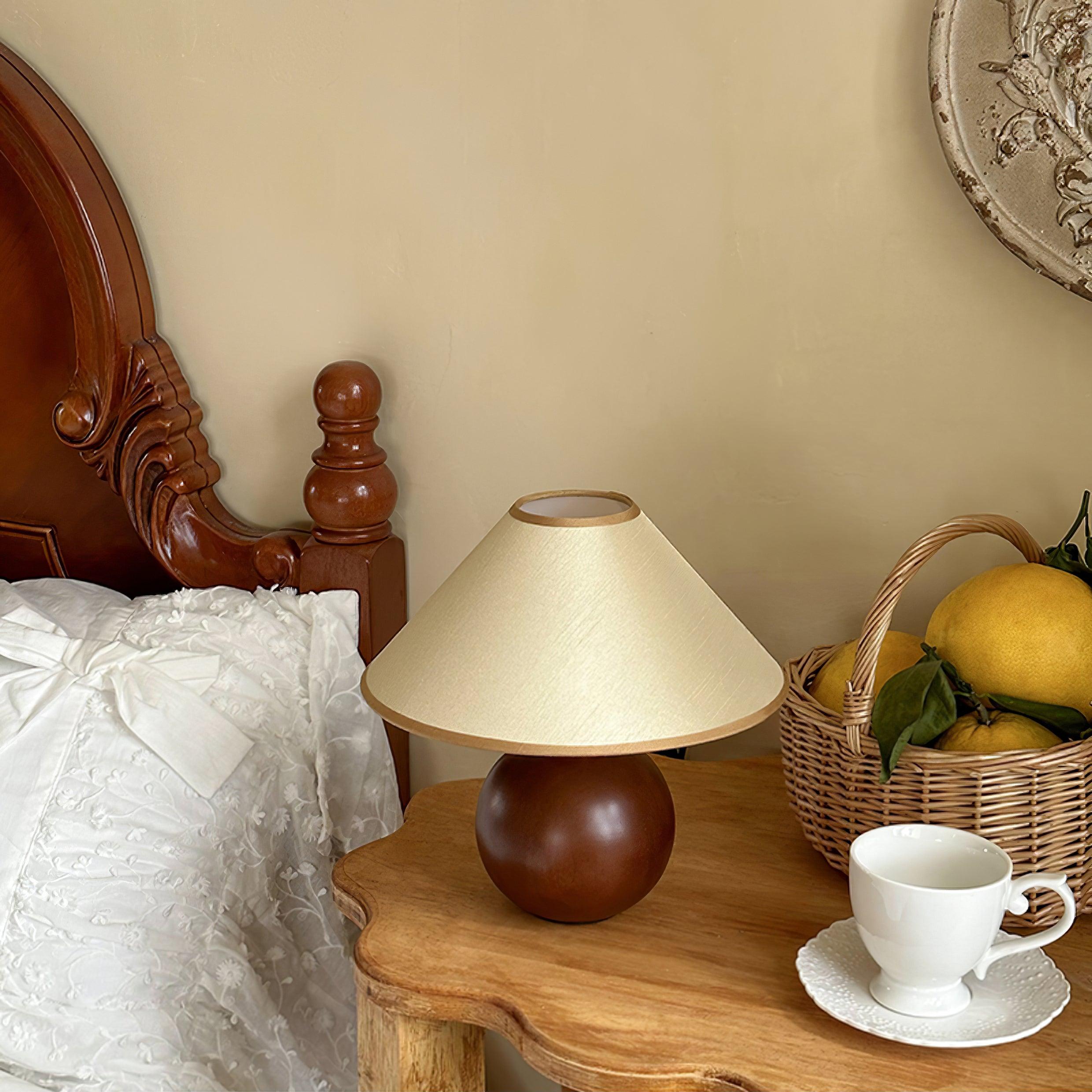 Wooden table lamp in vintage bedroom setting with wicker basket and lace linens, cozy bedroom ambiance