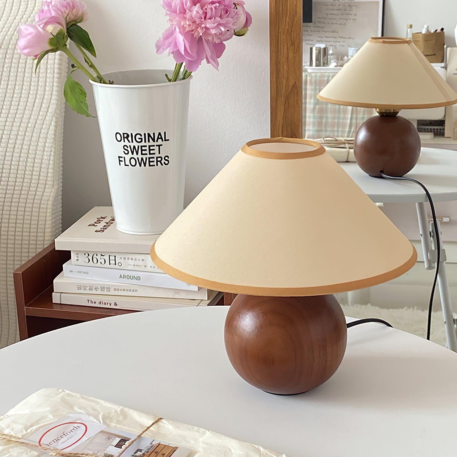Natural wood table lamp on living room side table with flowers and books, contemporary home lighting