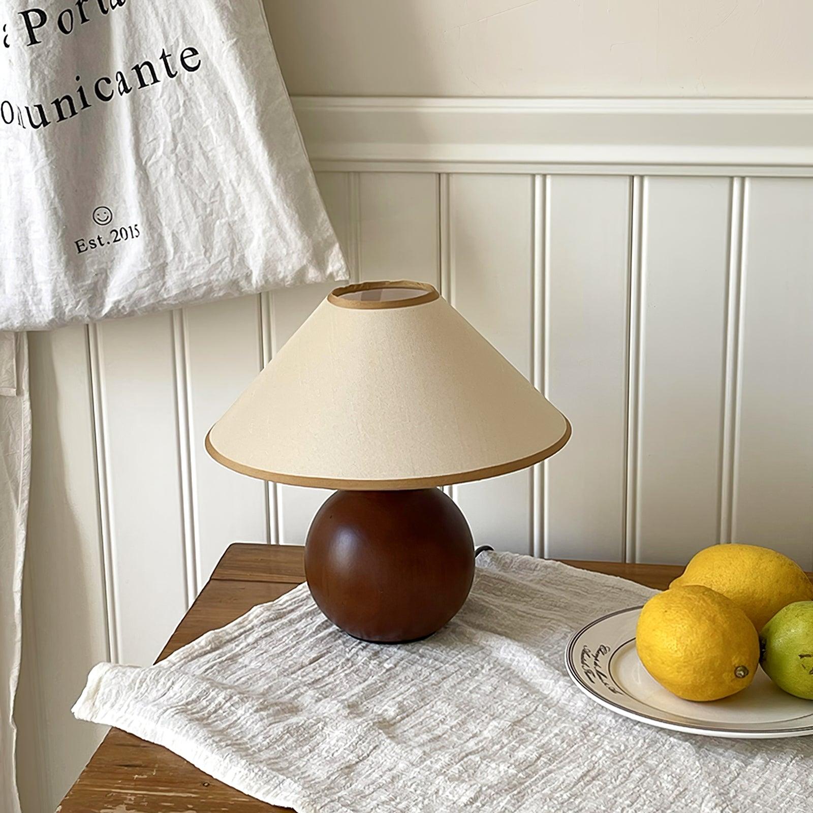 Walnut wood table lamp with hemp shade, close-up detail of natural wood grain and fabric texture
