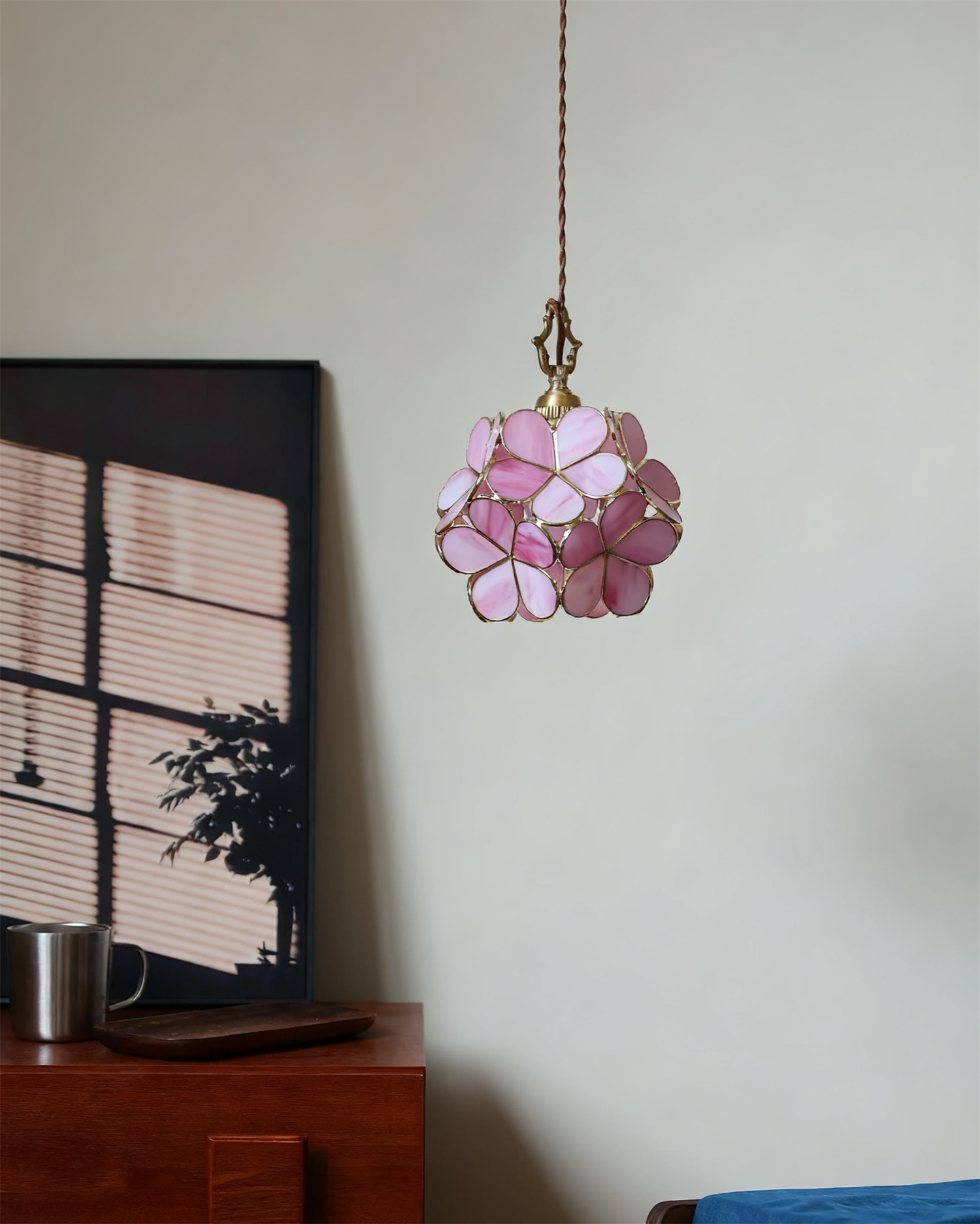 Dark pink flower stained glass pendant light glowing softly in minimalist home corner
