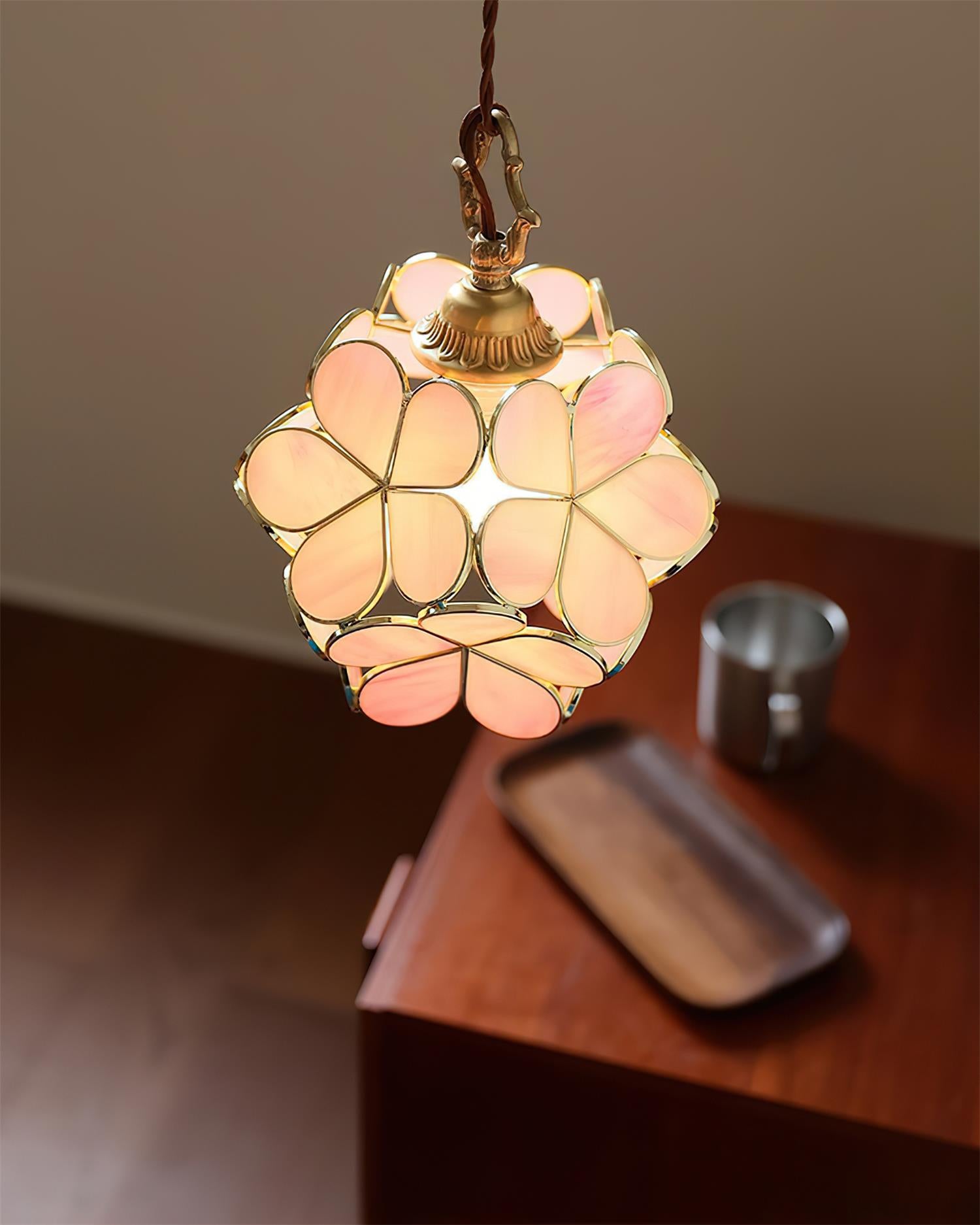 Pink floral stained glass pendant light with brass frame showcasing handcrafted artistry