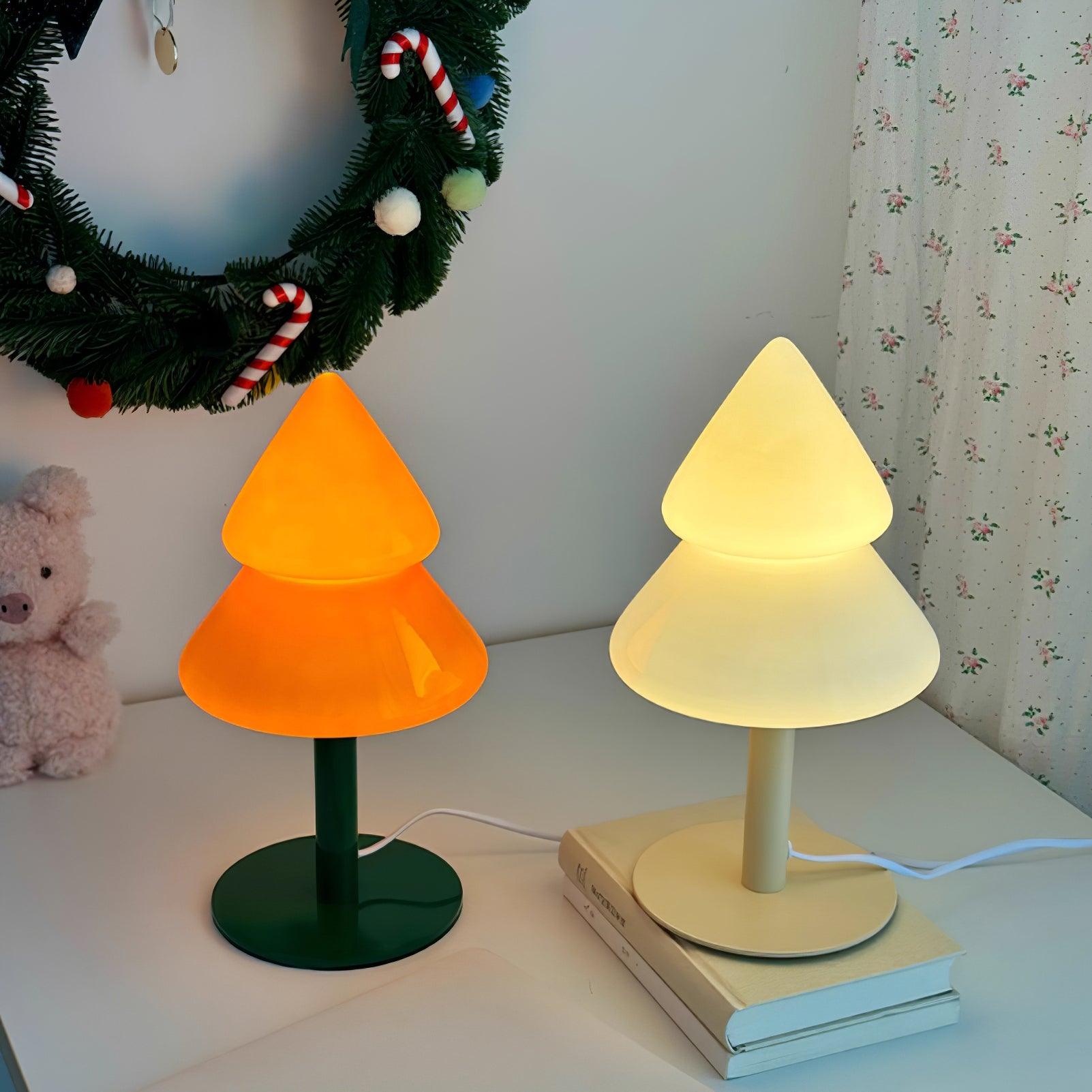 Glowing Christmas tree table lamps with warm LED light in holiday home office desk setup