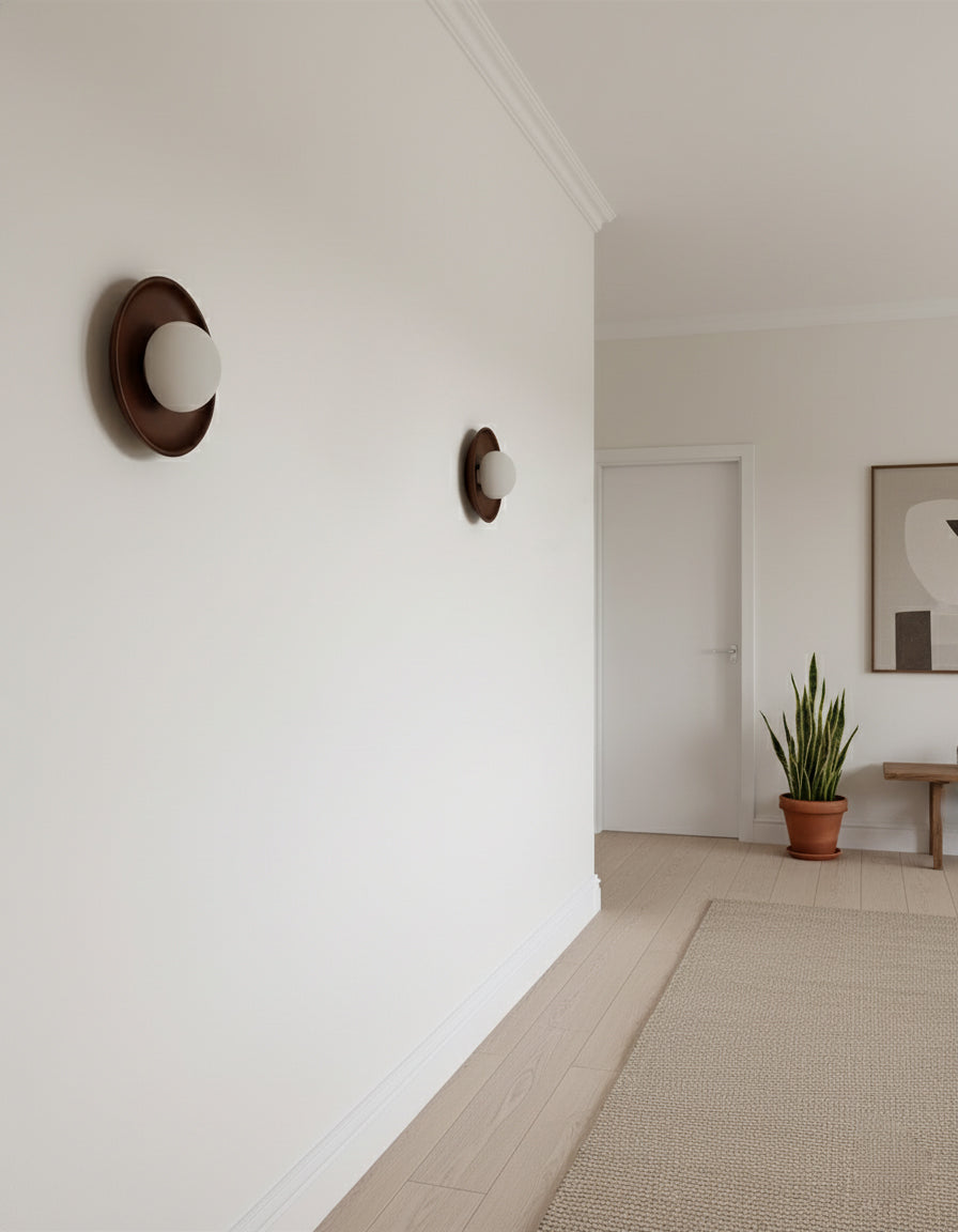 Round frosted glass wall sconce with natural wood finish close-up detail