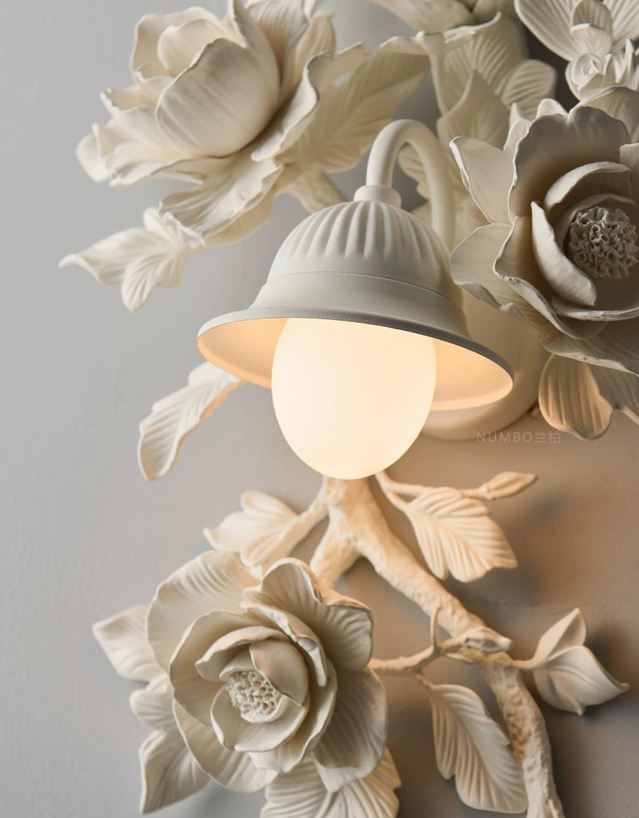 Elysia Bloom wall sconce architectural detail, hand-carved gypsum-resin roses and branch construction close-up