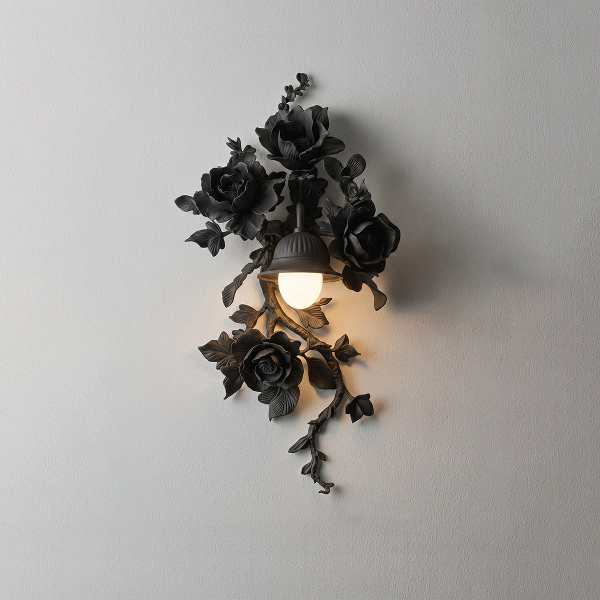 Black matte Elysia Bloom hand-carved rose wall sconce, eye-level mounted wall view with warm downward lantern glow