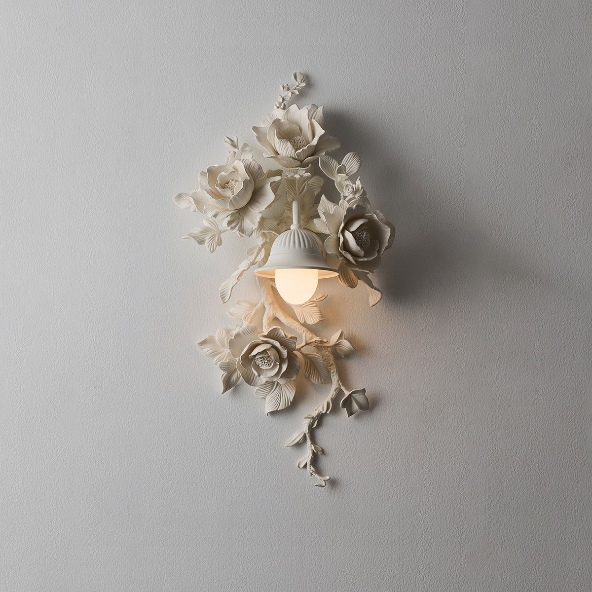White Elysia Bloom sculptural rose wall sconce in transitional interior, hand-carved floral relief casting soft shadows