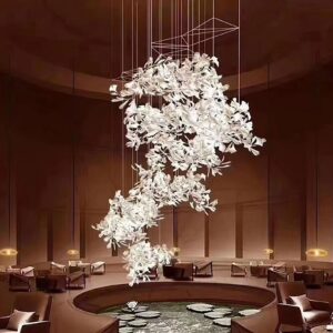Modern ginkgo pendant chandelier in pure white ceramic installed in luxury hotel lounge with water feature
