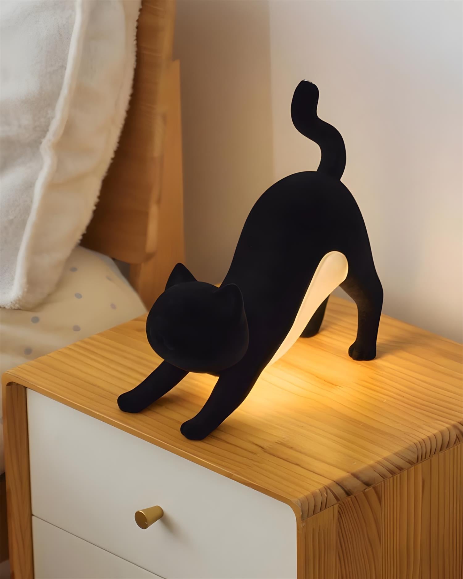 Black Hakimi cat lamp on bedroom bedside table with USB charging port and warm light