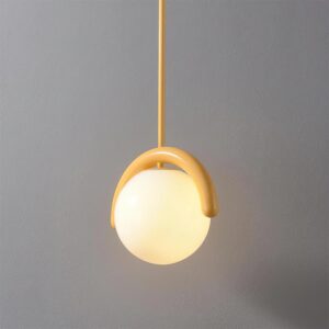 Contemporary globe pendant light with warm yellow bracket and illuminated frosted shade, three-quarter angle view