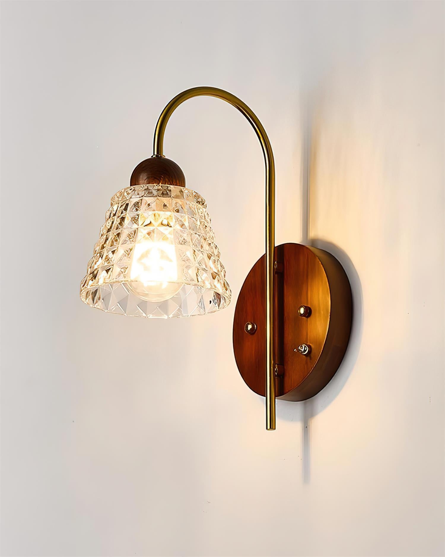 Lysora wall sconce close-up detail, brass arm connection, wooden walnut backplate
