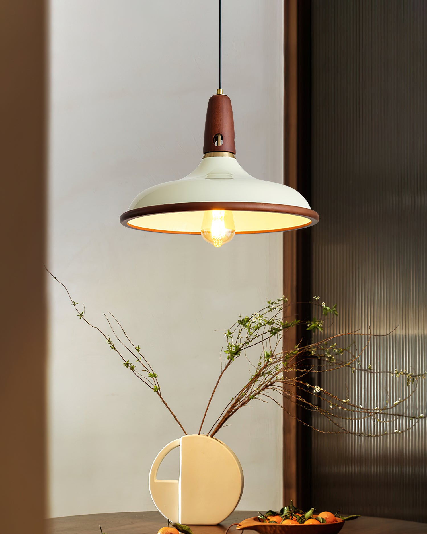Retro pendant lamp above dining corner with cream shade and dark wood trim, elegant table setting