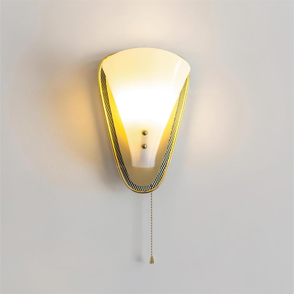 Marzio mid-century wall sconce illuminated casting warm ambient light with brass trim and vintage pull chain