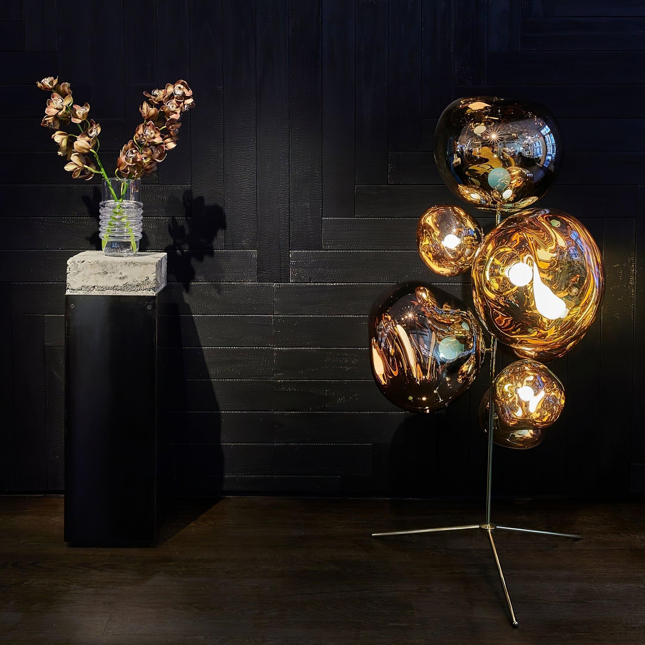 Gold metallic bubble floor lamp creating warm ambient light in elegant home setting