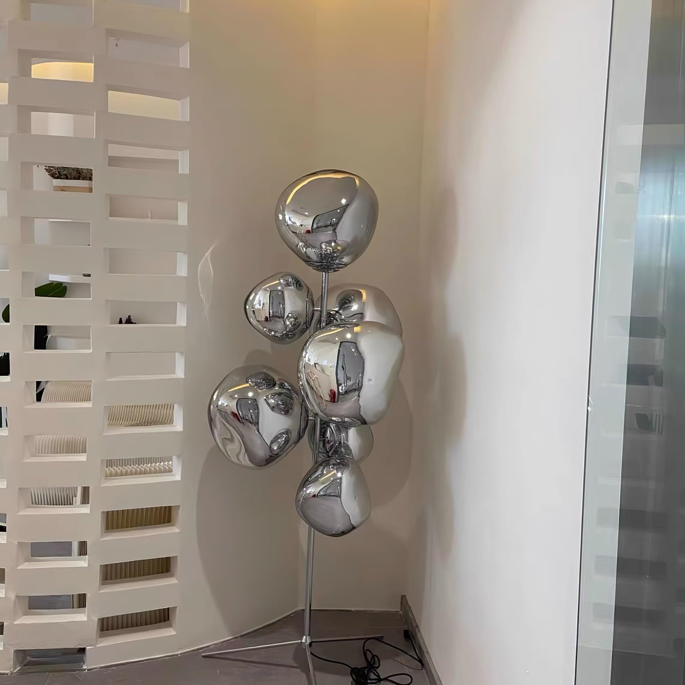 Modern bubble floor lamp illuminated showcasing warm light refraction through glass shades