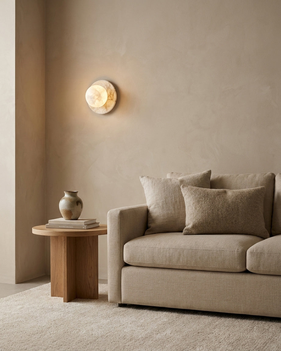 Mia Ball Wall Sconce glowing softly in contemporary neutral living room beside linen sofa, organic modern interior