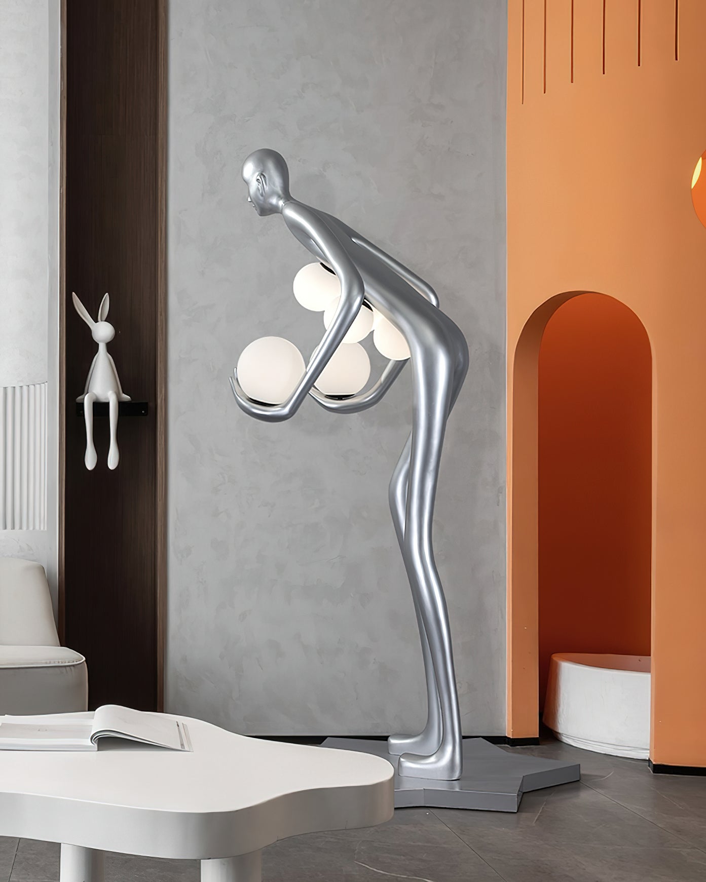 Contemporary art floor lamp in silver with human silhouette and glowing frosted globe lights in modern residential interior