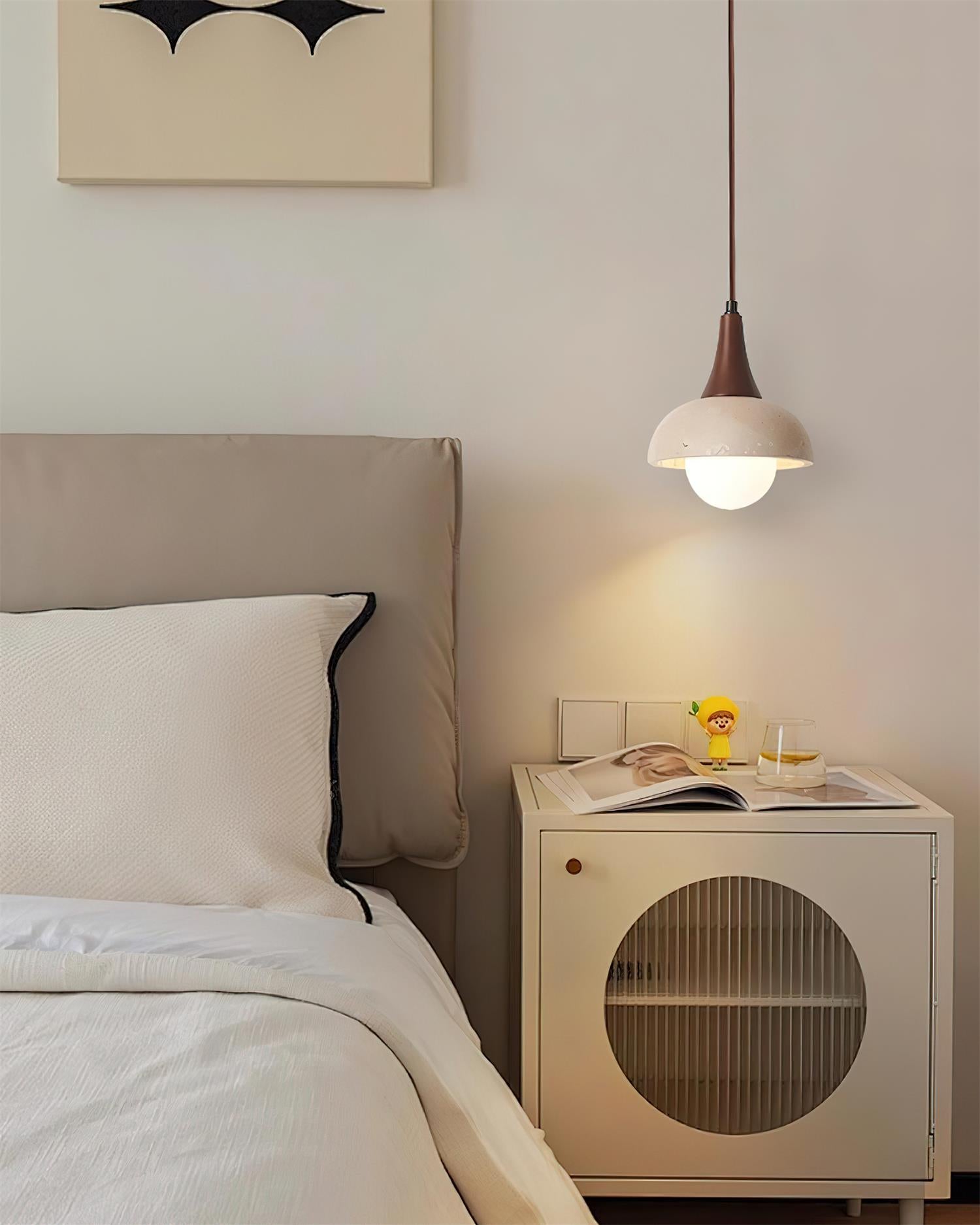Single dome travertine pendant light installed above modern bedroom nightstand creating warm ambient bedside lighting