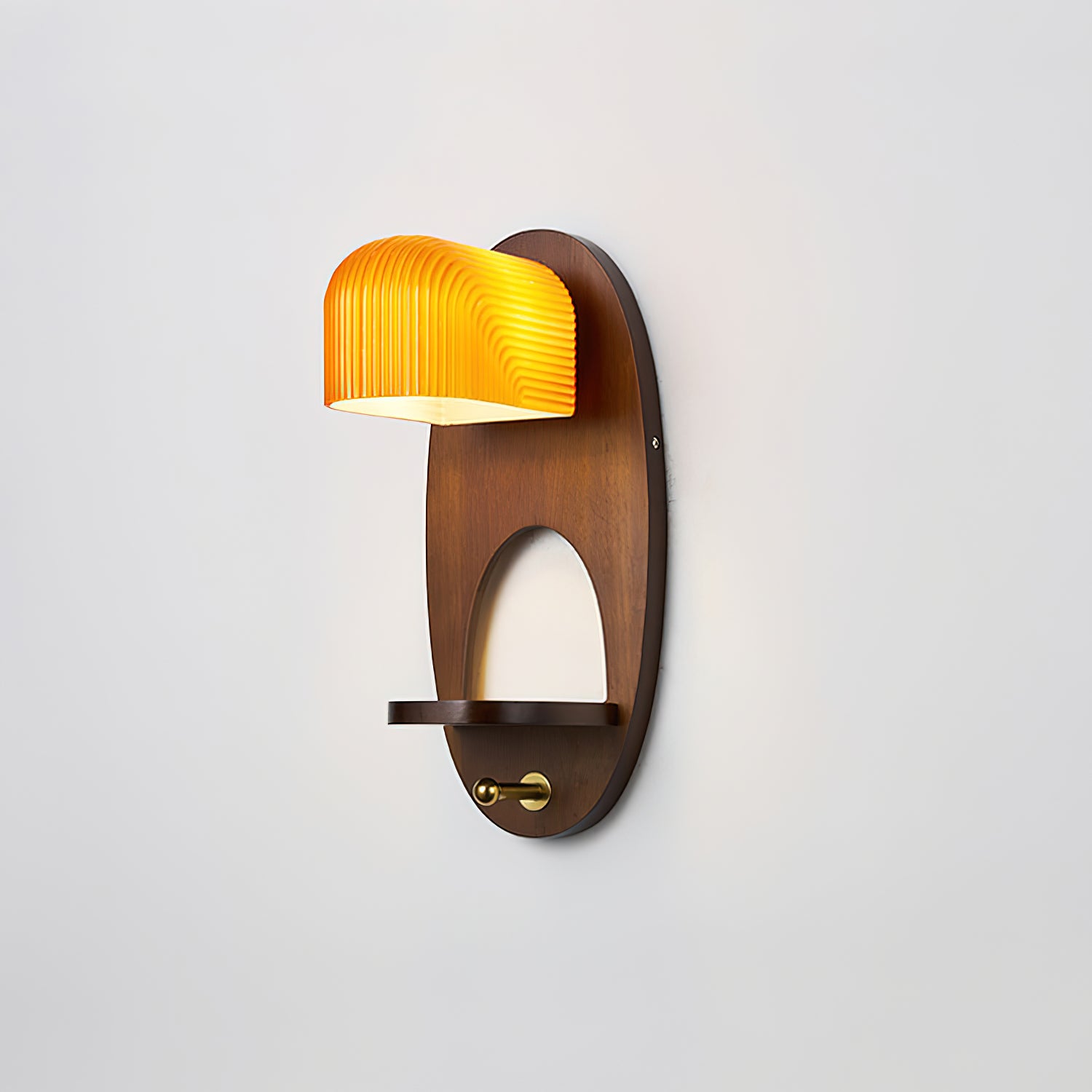 Orenso contemporary wall sconce angled view highlighting oval wooden base and ribbed amber glass shade