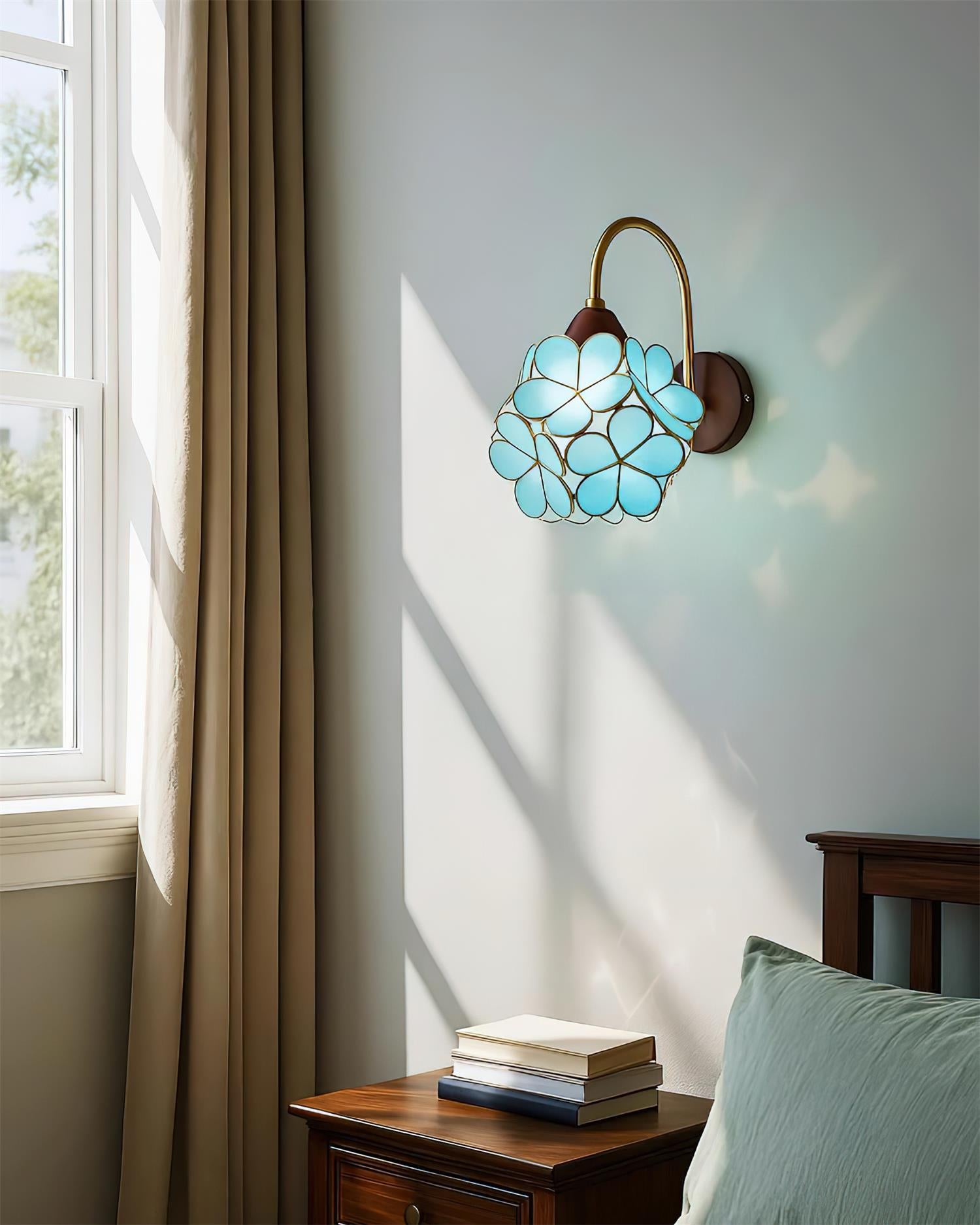 Petalora blue stained glass wall sconce side angle view casting blue floral light patterns