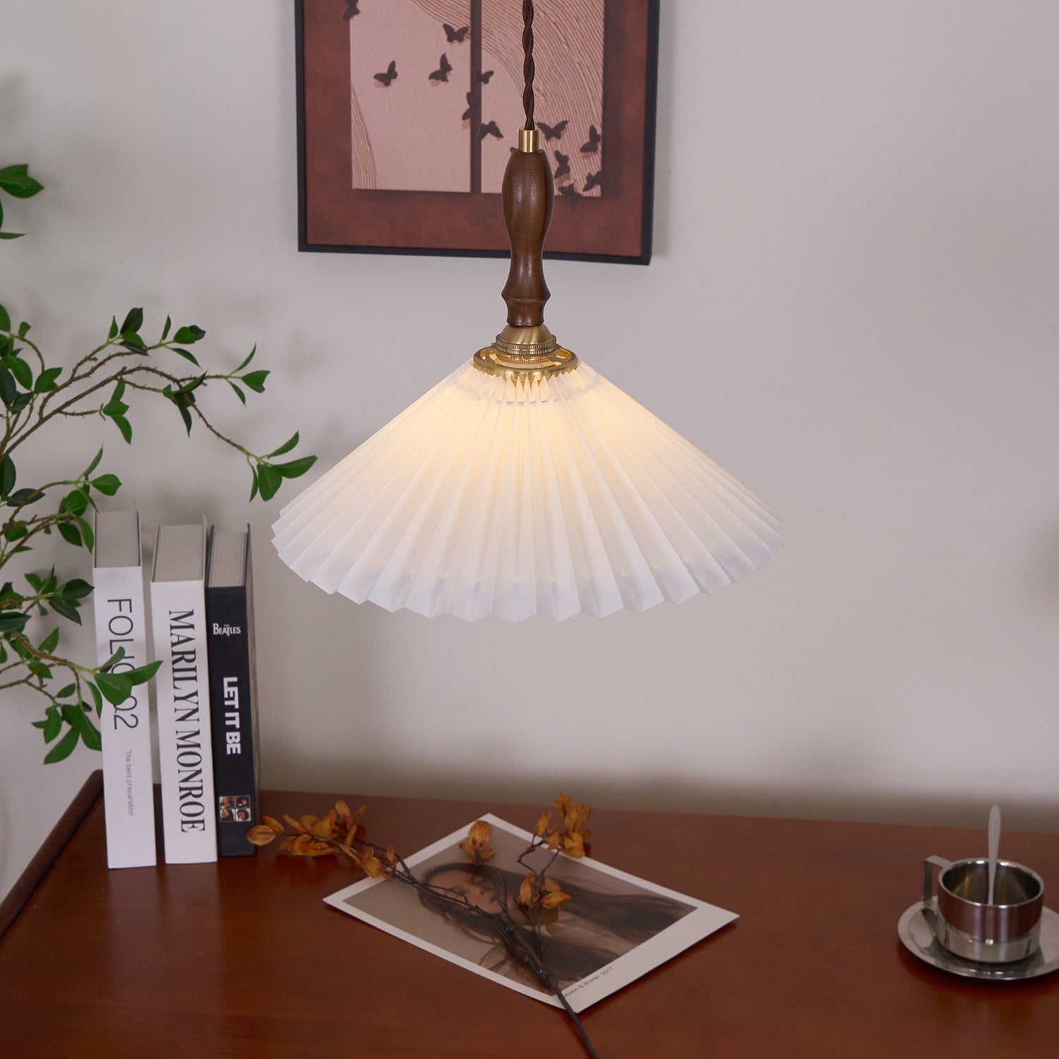 Pleated pendant light construction detail showing walnut wood frame and brass connection hardware