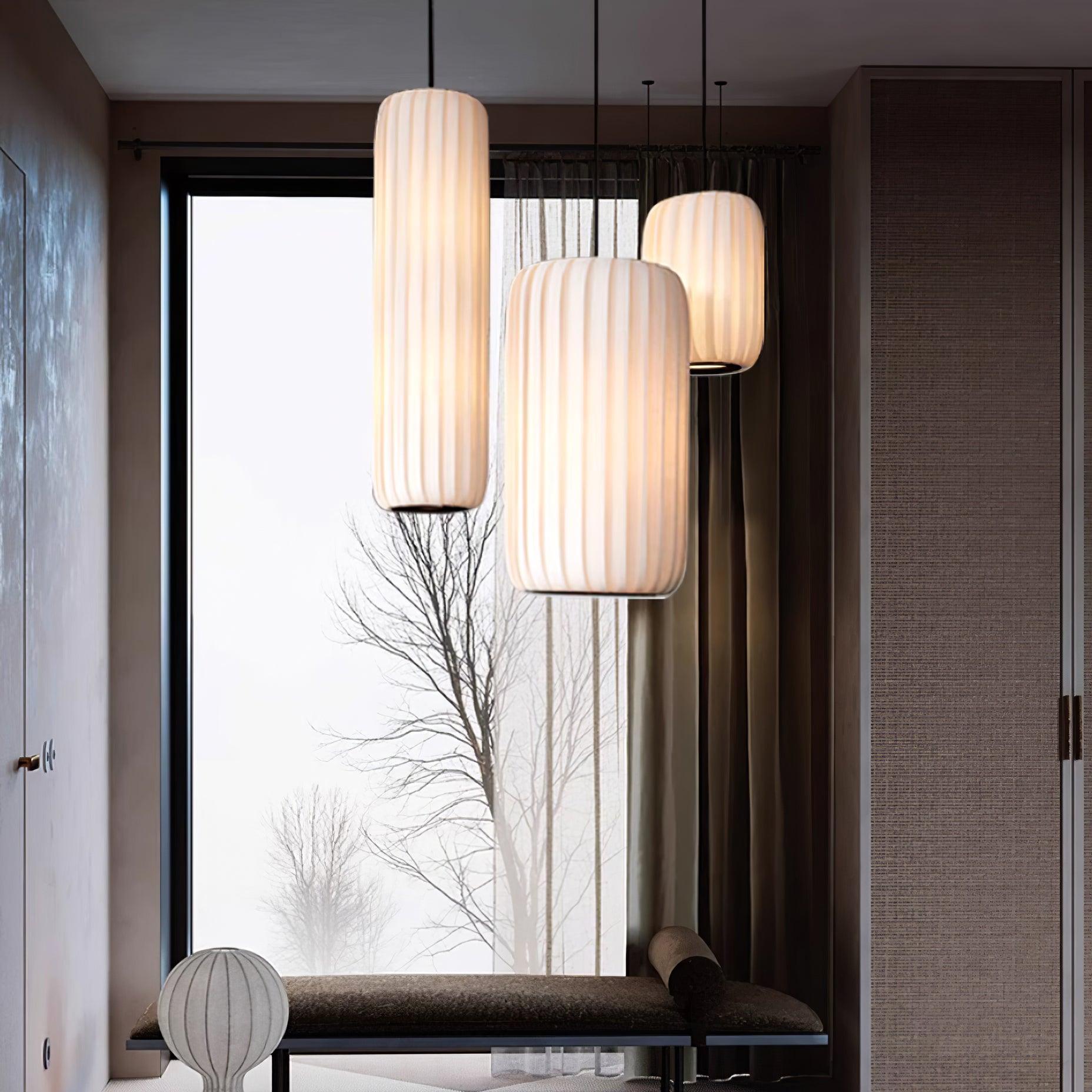 Minimalist fabric pendant light in contemporary living room with floor-to-ceiling window and neutral decor