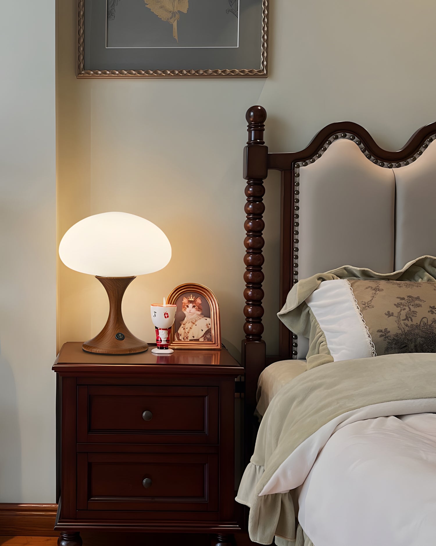 Sculptural bedside table lamp with warm opal glass shade and wooden base on traditional nightstand