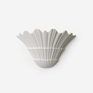 Shellora matte white ceramic shell wall sconce with fluted details studio shot