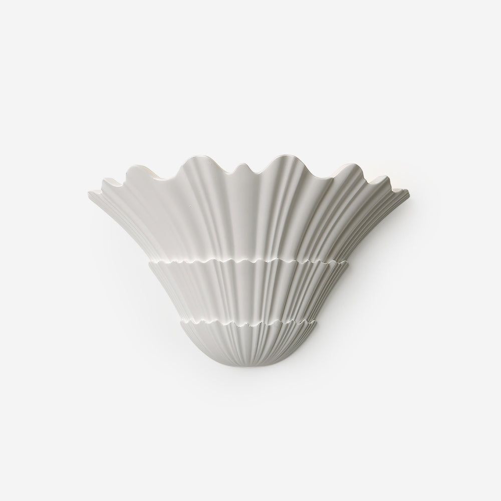 Shellora matte white ceramic shell wall sconce with fluted details studio shot