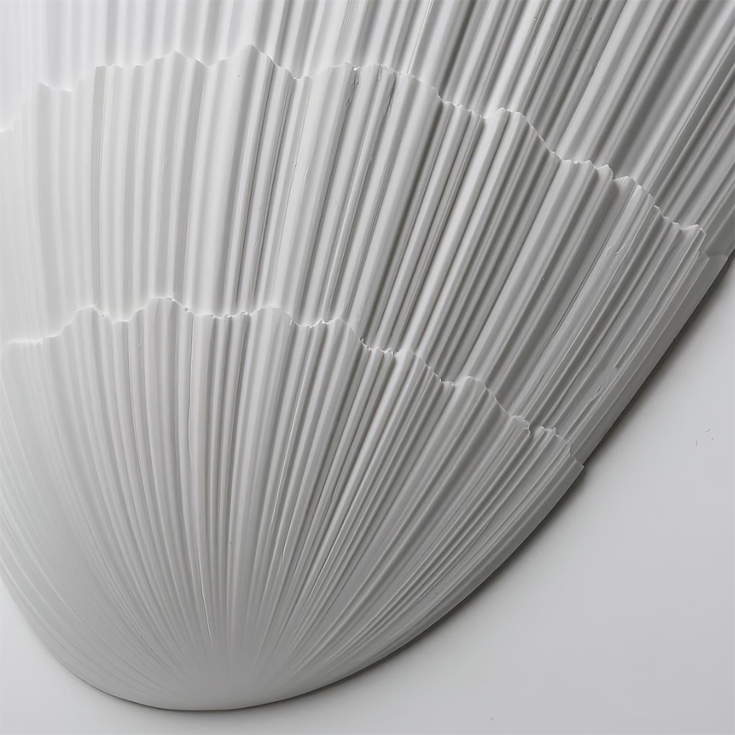 Shellora wall sconce angle view fluted ceramic shell surface detail