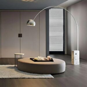 Contemporary arc floor lamp illuminating modern living room with round ottoman and minimalist décor