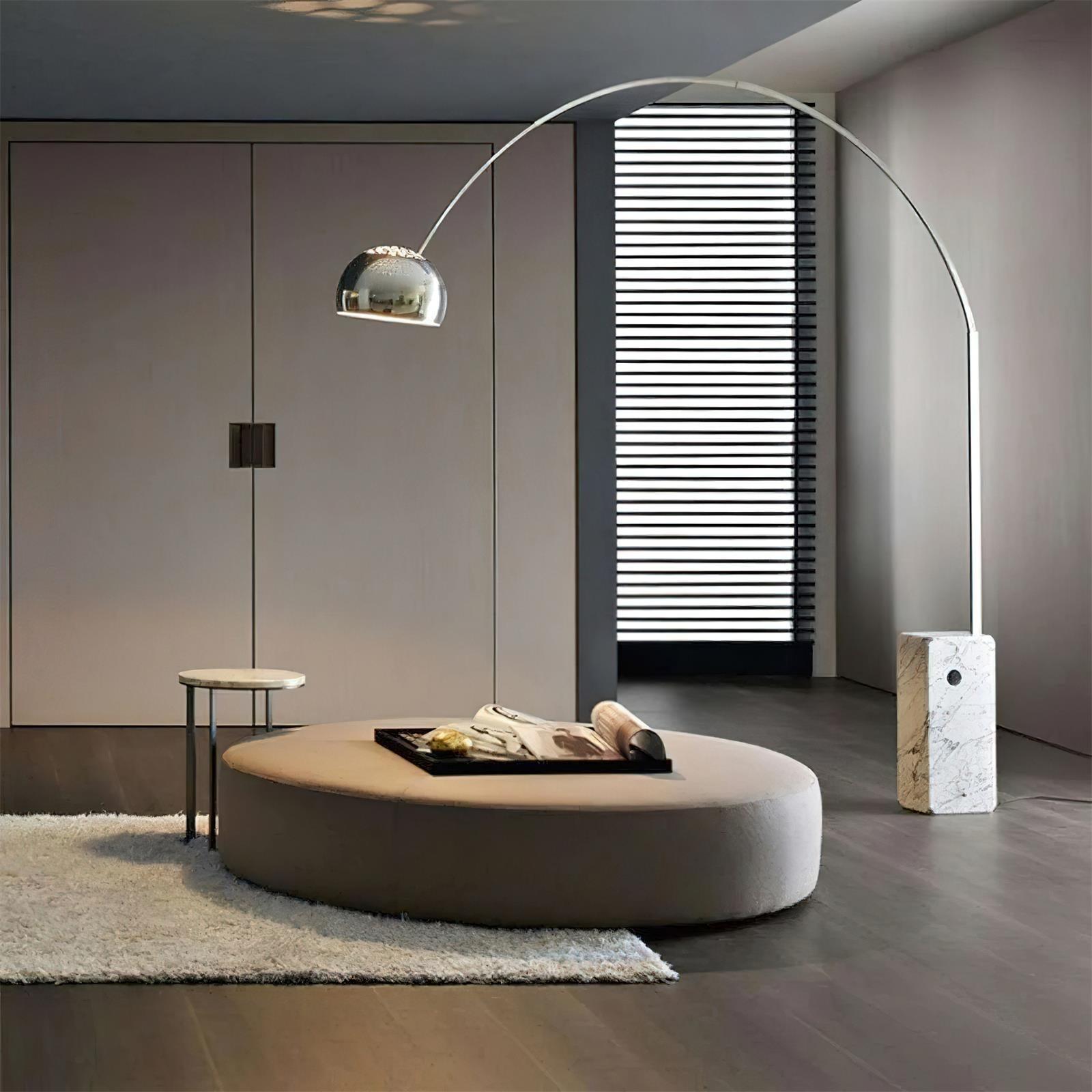 Contemporary arc floor lamp illuminating modern living room with round ottoman and minimalist décor