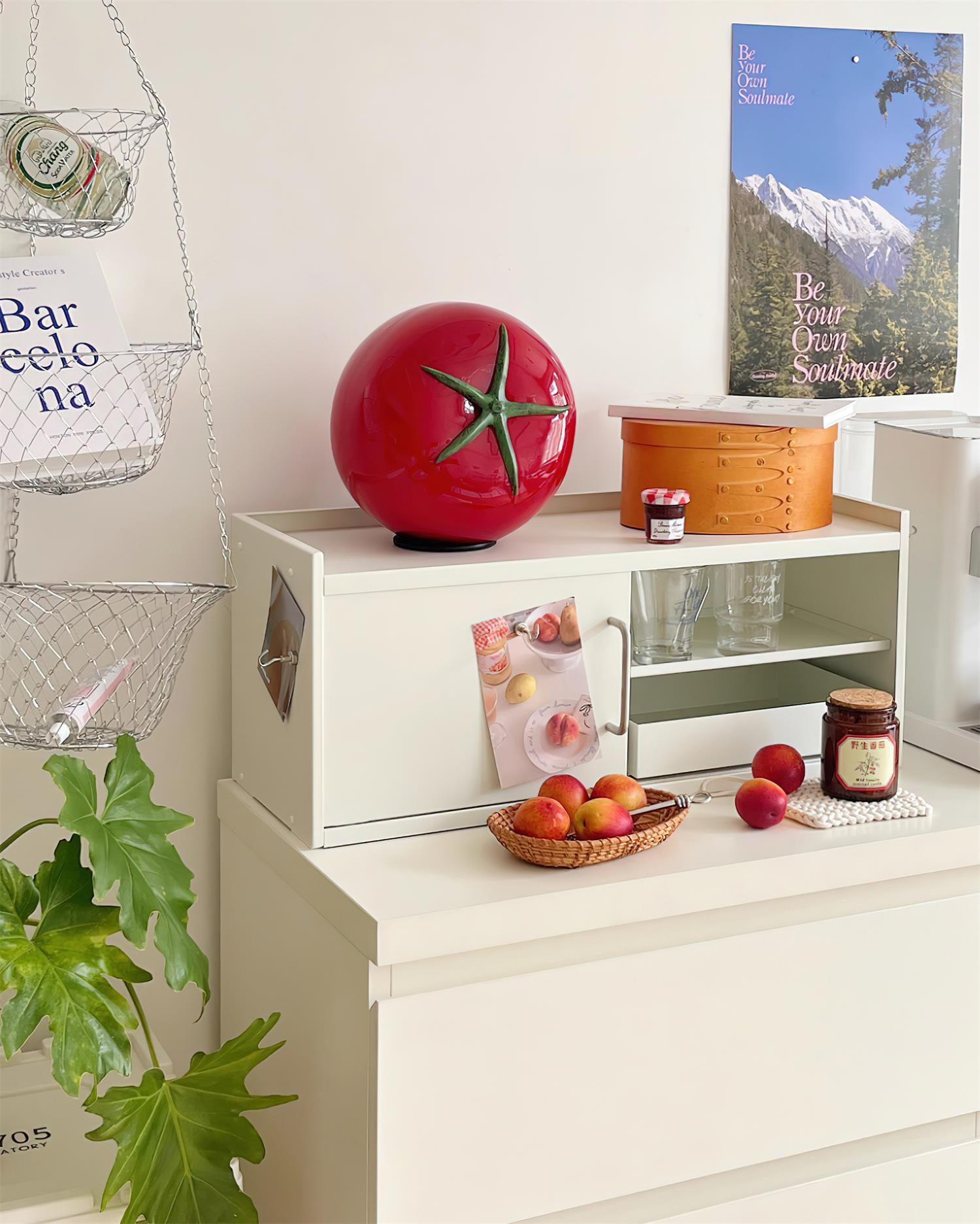Red tomato lamp on white dresser with kitchen accessories - contemporary decorative table light