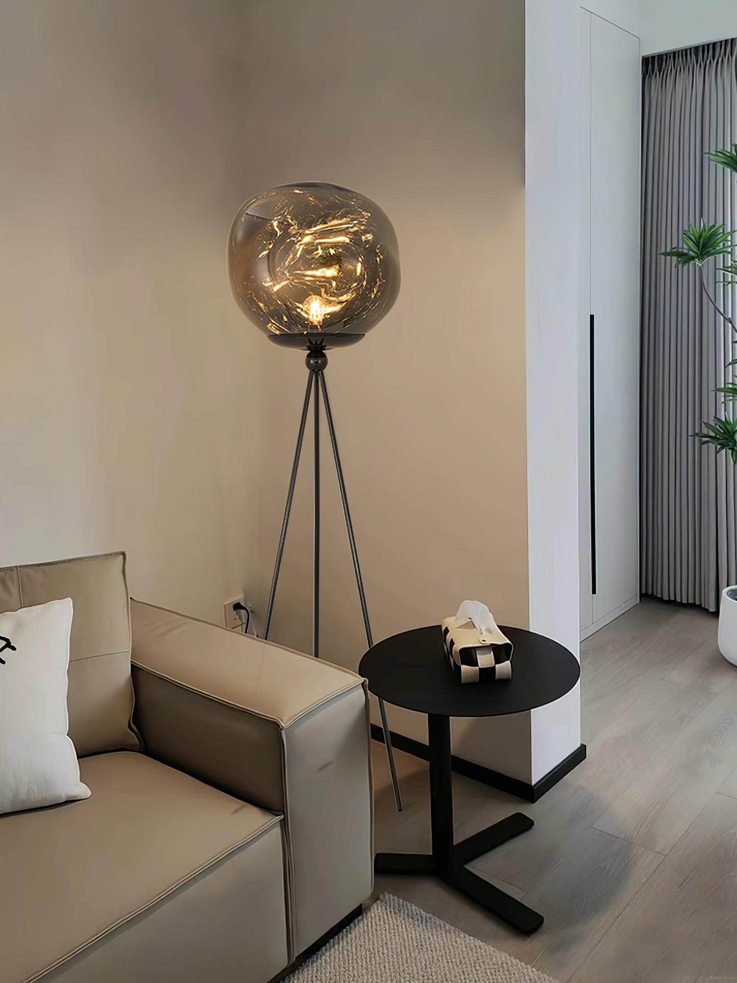 Modern artistic tripod floor lamp with molten glass shade and premium metal tripod frame construction