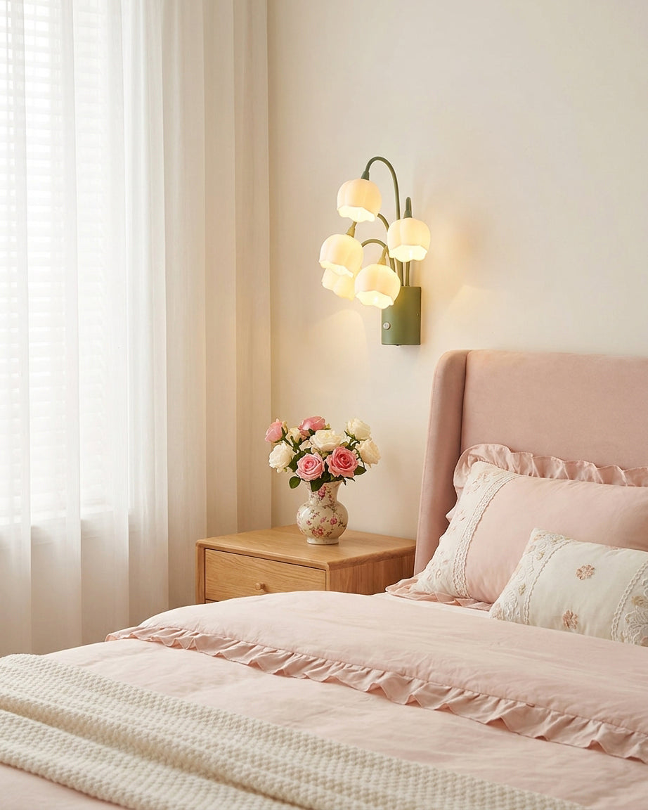 Pink bedroom with upholstered bed featuring rechargeable wireless wall sconce as bedside night light accent