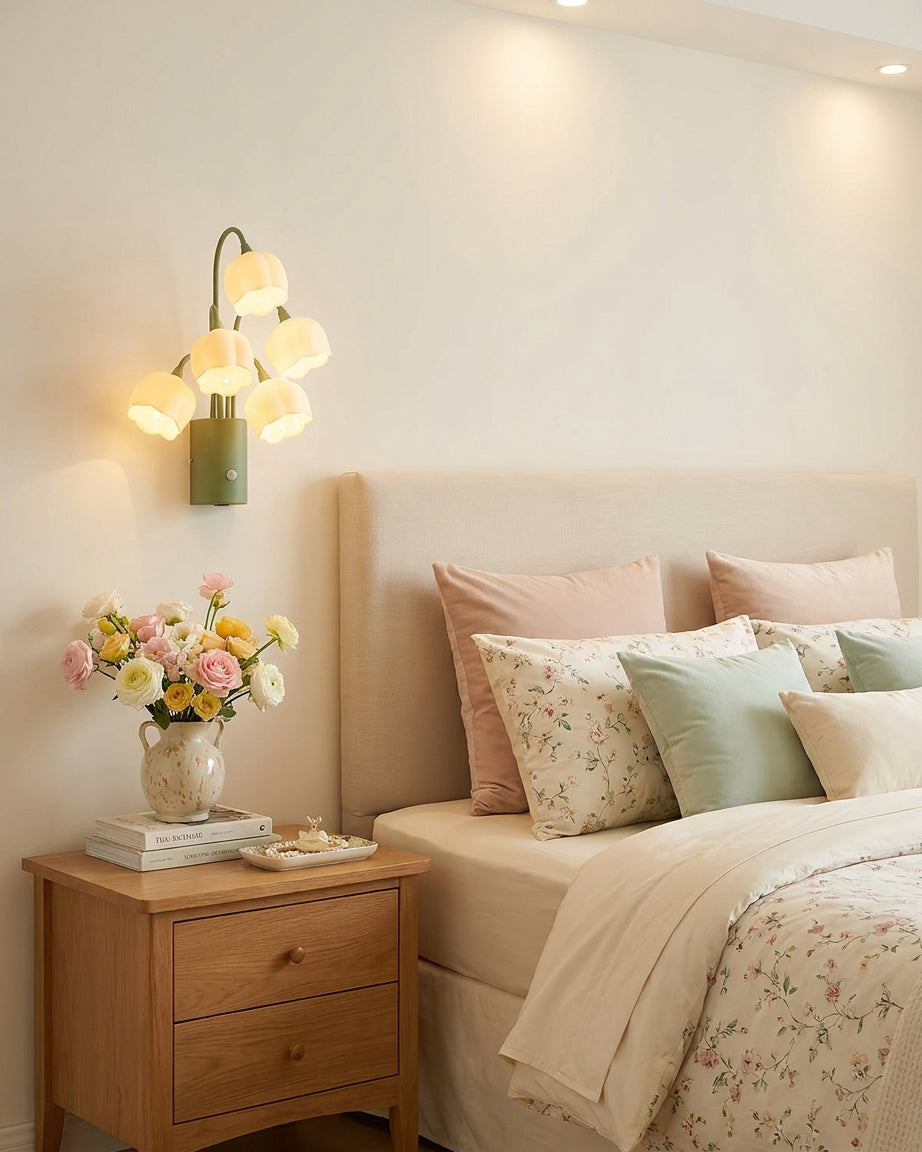 Master bedroom with wooden nightstand and floral bedding featuring soft romantic lily-of-the-valley motion sensor wall sconce