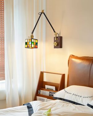 Stained glass swing arm wall sconce mounted in bedroom bedside setting with warm ambient illumination, demonstrating mid-century vintage aesthetic and bedroom task lighting application