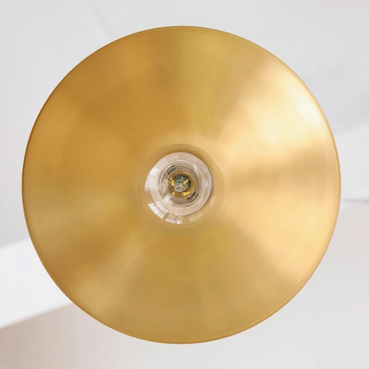 Classic 1950s style brass pendant lamp with wide conical shade in traditional home interior