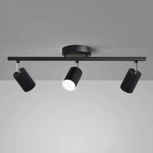 Black track lighting system with 3 adjustable spotlight heads, three-quarter angle view against grey wall