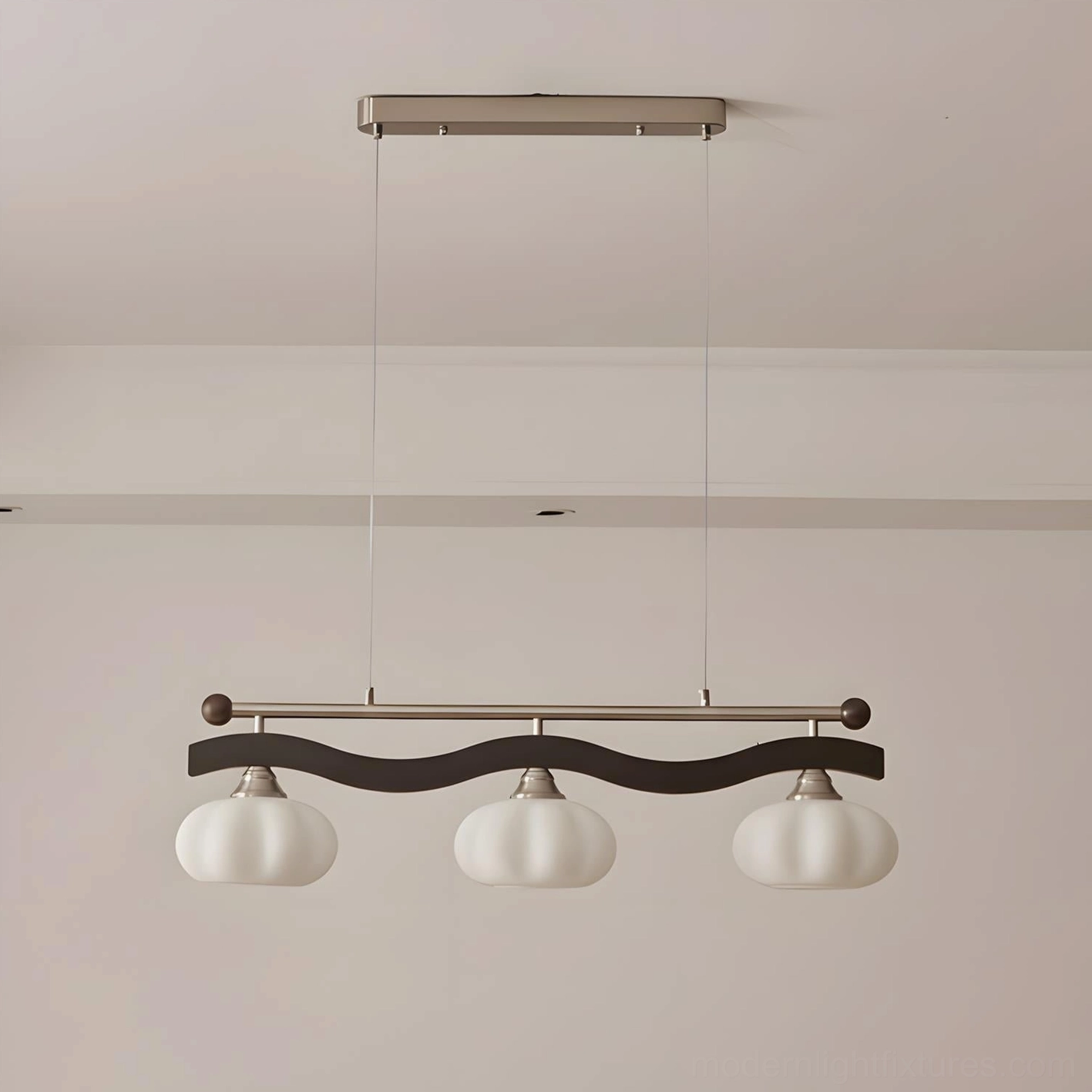 3-head modern linear chandelier with wave metal frame and frosted glass domes in minimalist interior setting