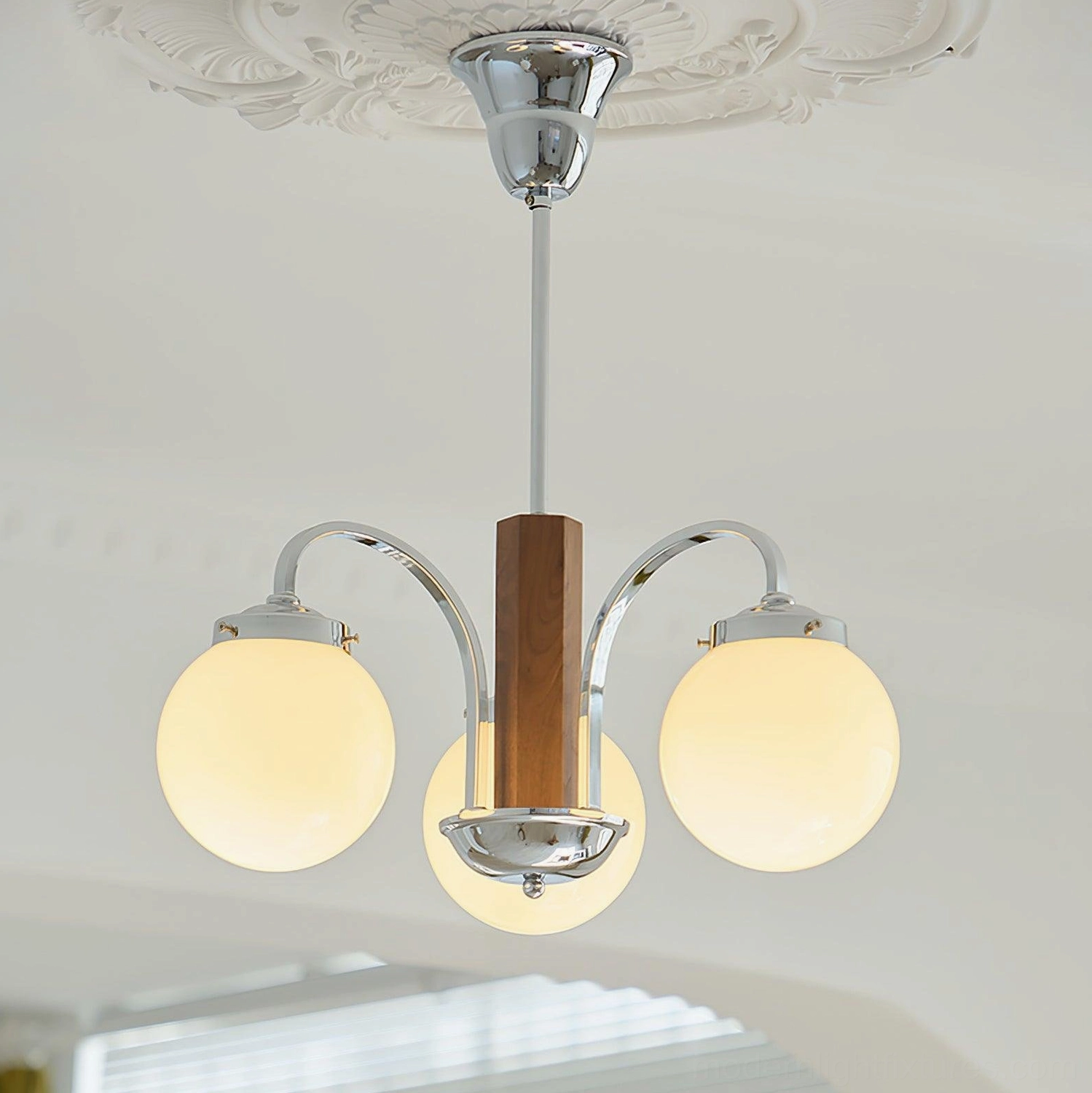 3-light Polaris globe chandelier low angle view chrome metal construction frosted glass shades