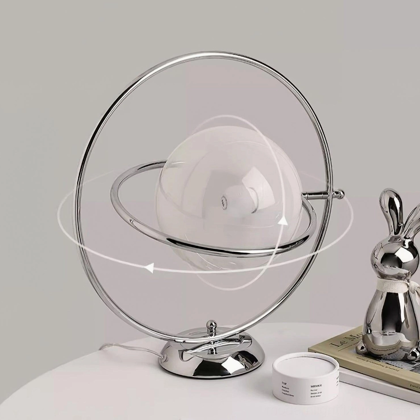 Modern adjustable rotating planet lamp with chrome metal base and decorative accessories