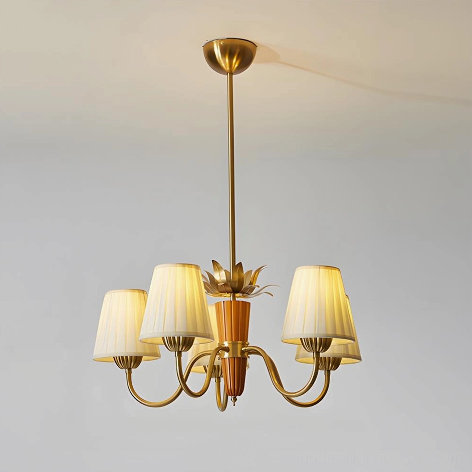 5-head mid-century modern chandelier with brass frame and pleated beige fabric shades, studio photography