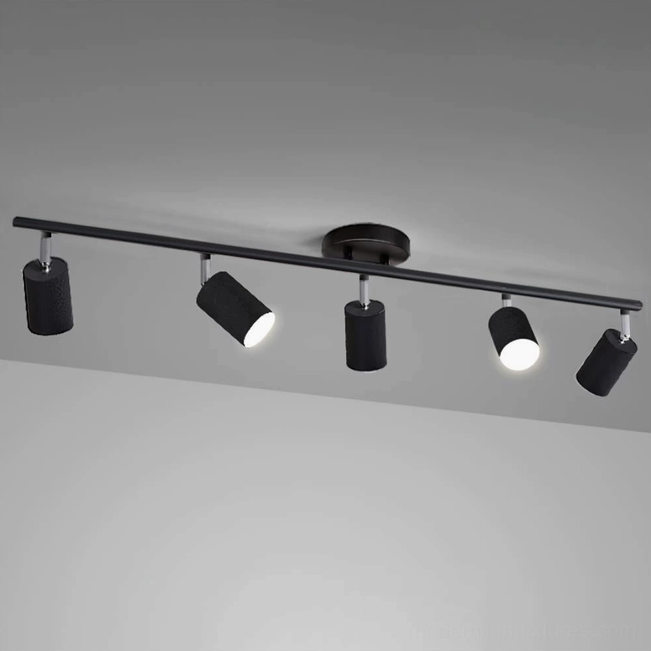 White adjustable track lighting system with 5 directional spotlight heads, contemporary interior design style