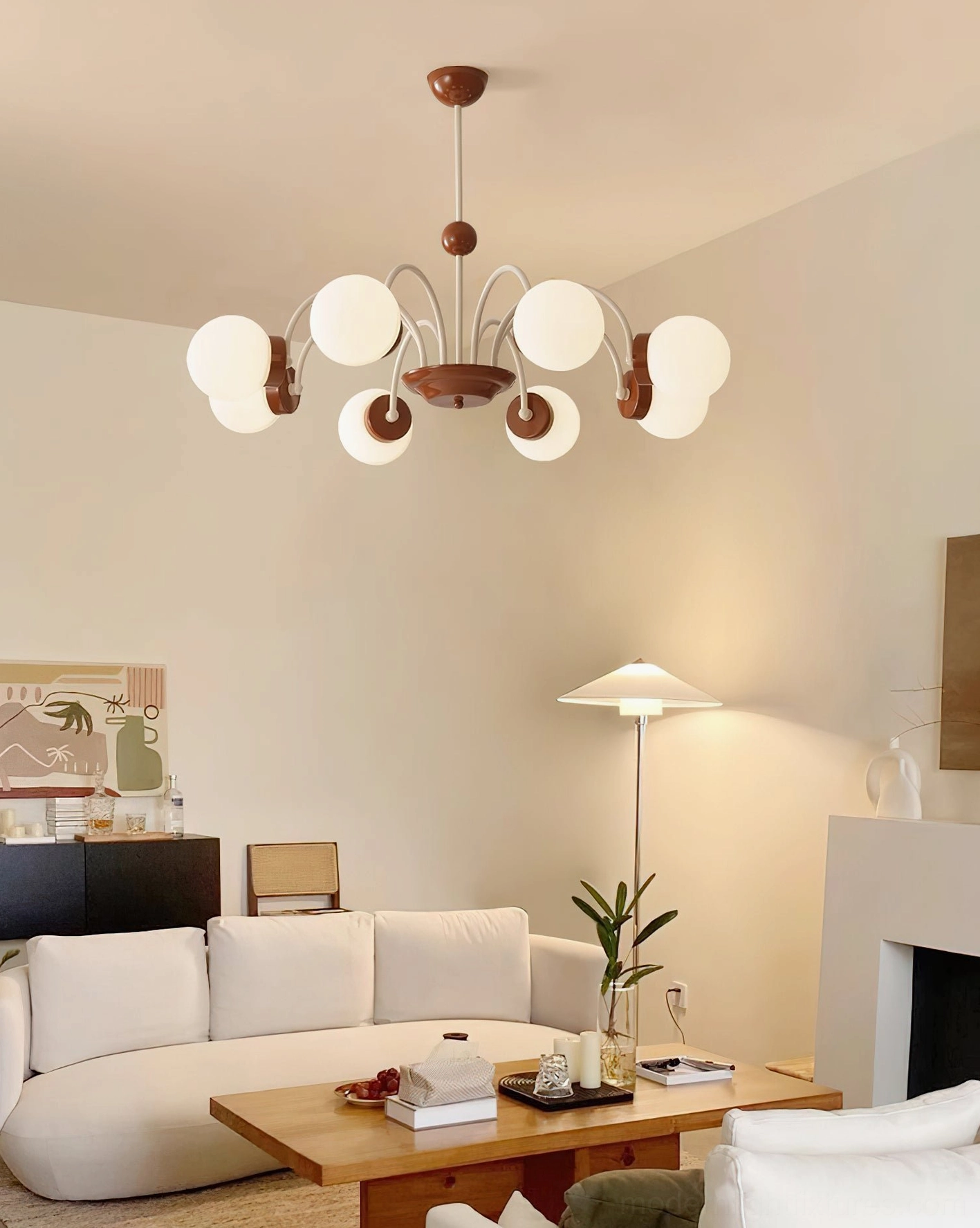 6-head glass globe pendant light in warm living room with brown and off-white metal arms, mid-century aesthetic